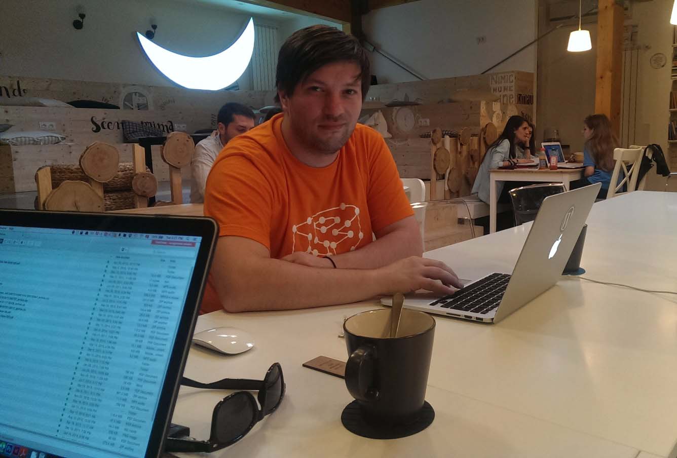 Alex Negoita, at his laptop, working on a WordPress website.